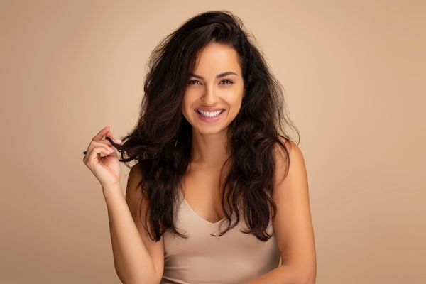 Woman with healthy, thick hair smiling